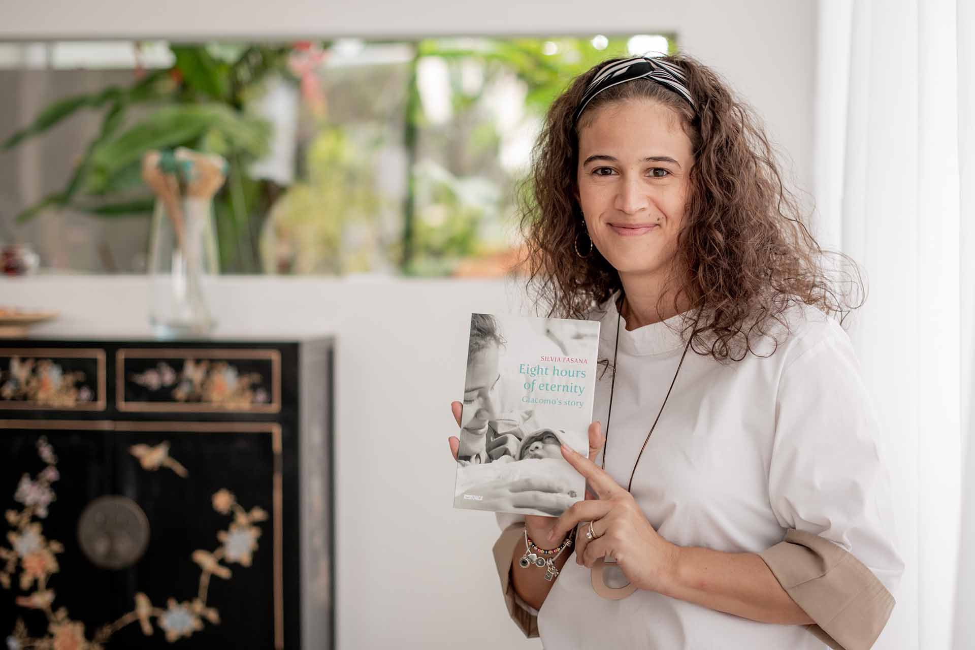 Silvia Fasana holding her book - Eight Hours of Eternity.