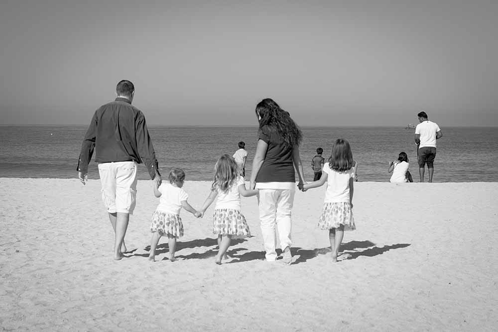 Silvia with her kids by the beach.