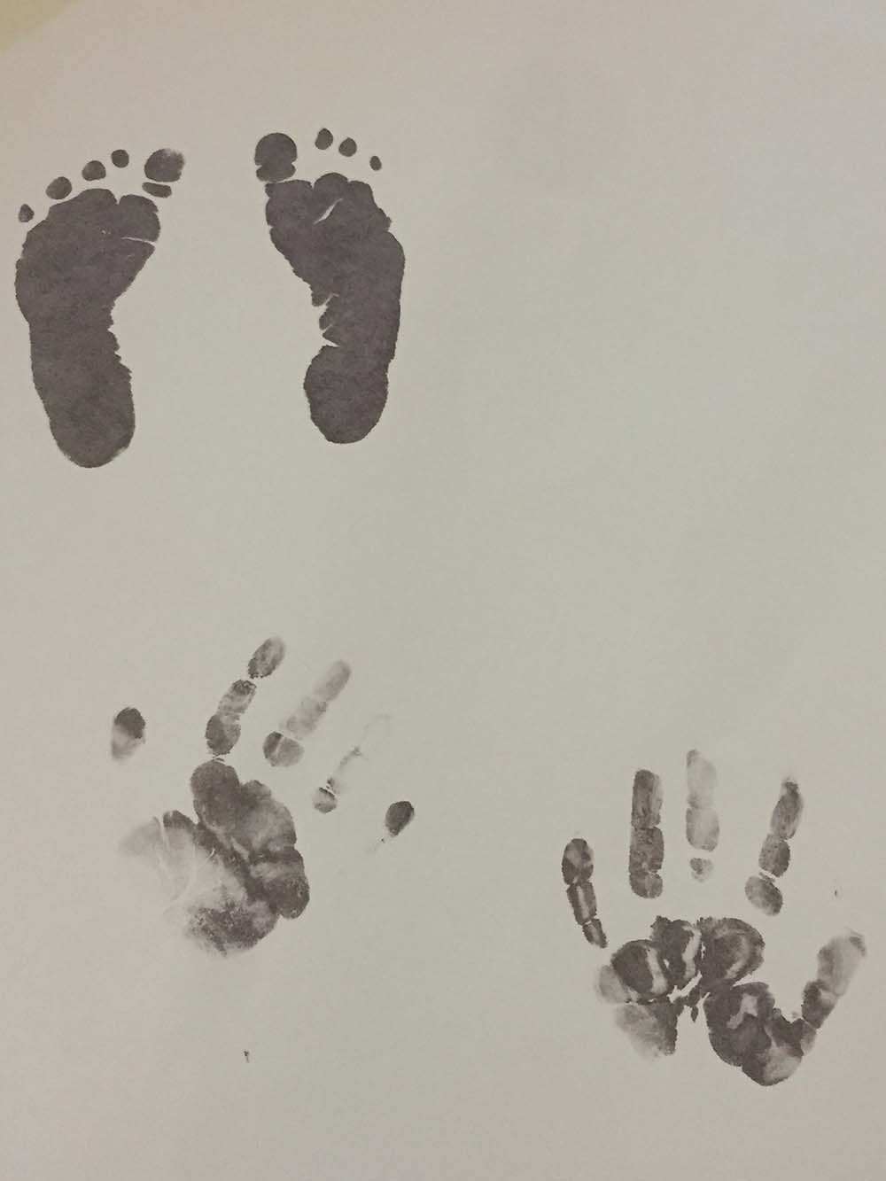 Footprints and palm prints on a paper.